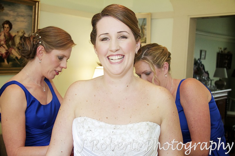 Bride having dress done up - wedding photography sydney